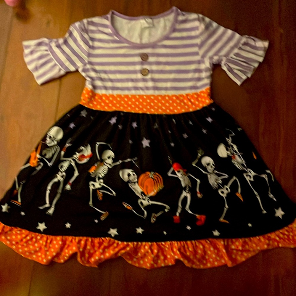 Halloween theme, all spooky colors, short ruffle sleeves, ruffle at the bottom.